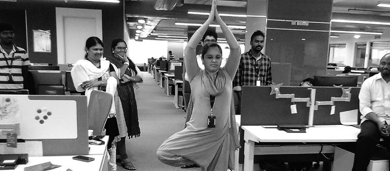 Person performing Yoga asana in an office setting